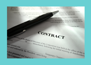 What to Do When a Client Tries to Poach Your Cleaner. Picture of a pen resting on top of a contract. Maid In Business Blog.